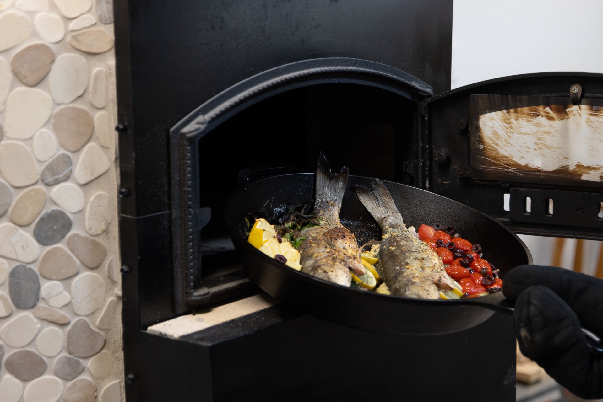 The oven mouth with a cast-iron pan inside